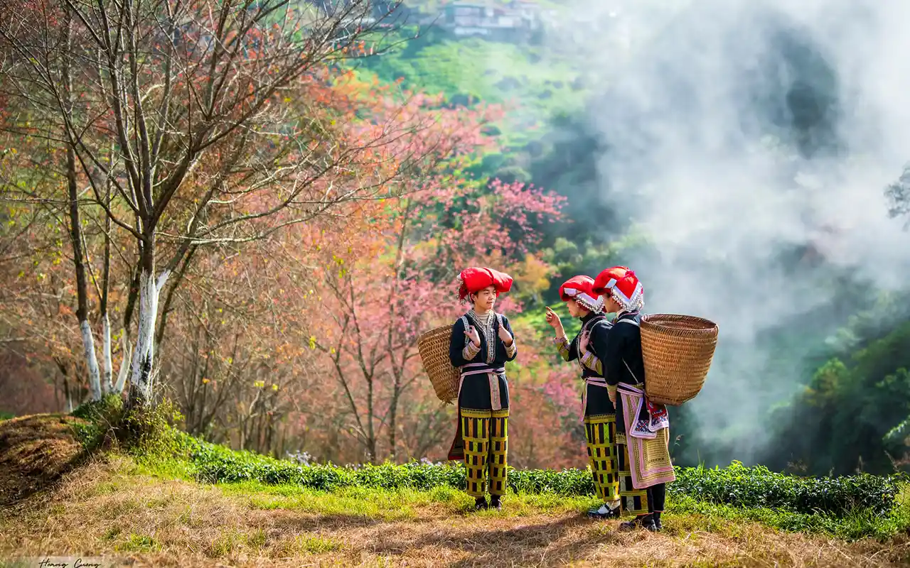 Three children in traditional dress with baskets outdoors